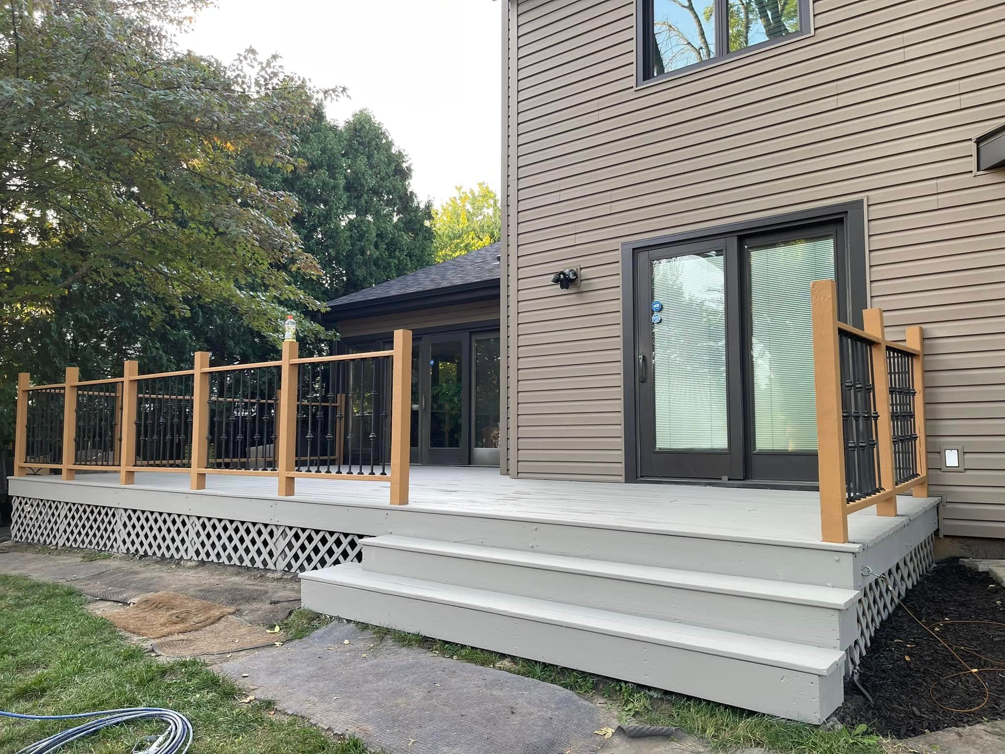 Backyard deck with stained railings and refreshed deck surface